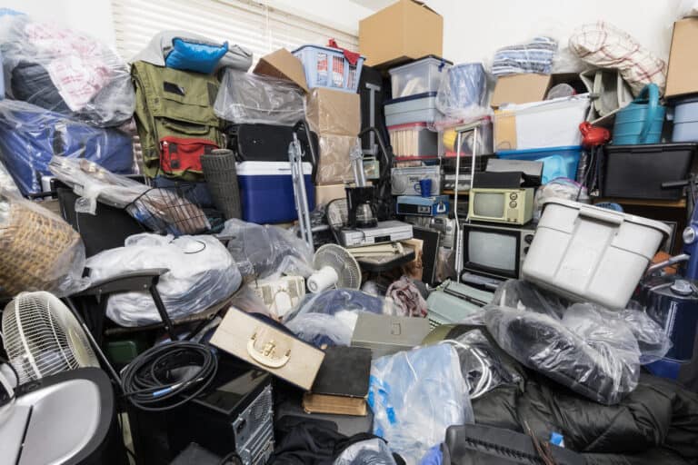 Cluttered hoarder house filled with household items and storage boxes in Jacksonville, FL.