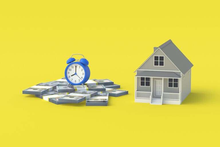Clock on money stacks next to a house model on yellow background.