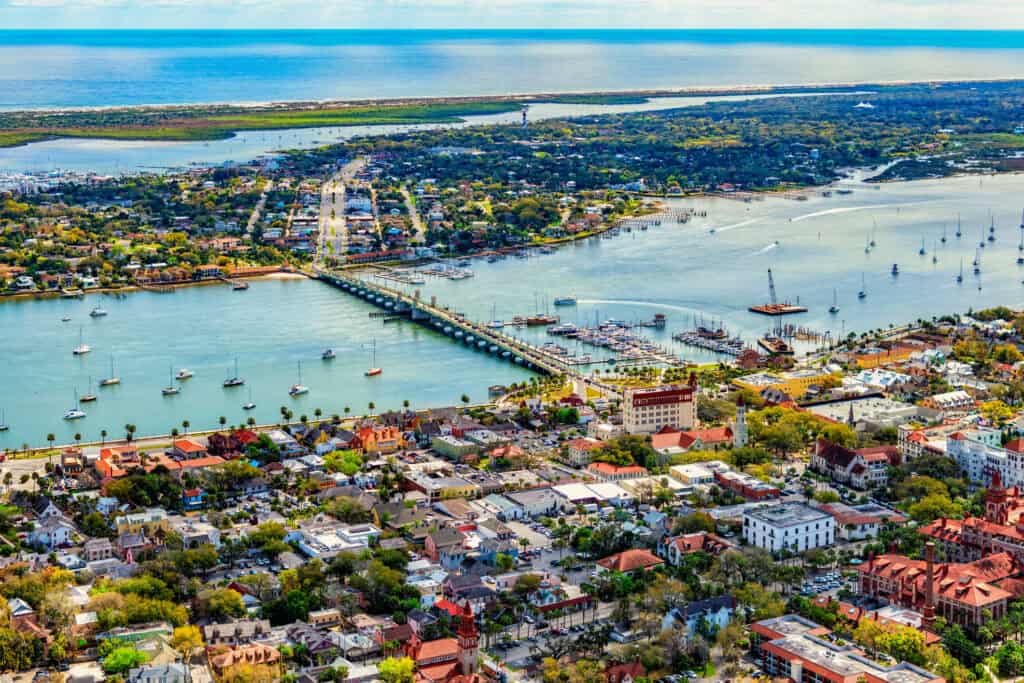 Aerial view of St. Augustine, FL, showcasing the waterfront and historic downtown.