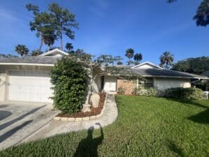 Single-story home with lush front yard and palm trees in Ponte Vedra Beach, FL.